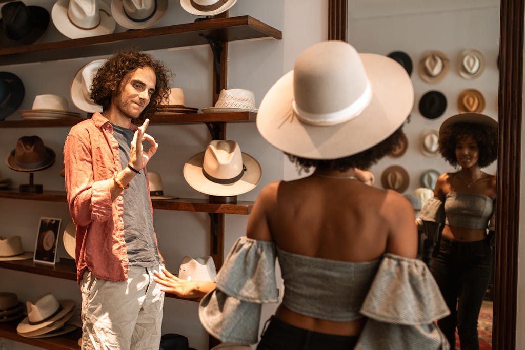 A fashionable couple explores a stylish boutique, trying on trendy hats and enjoying a day of shopping.