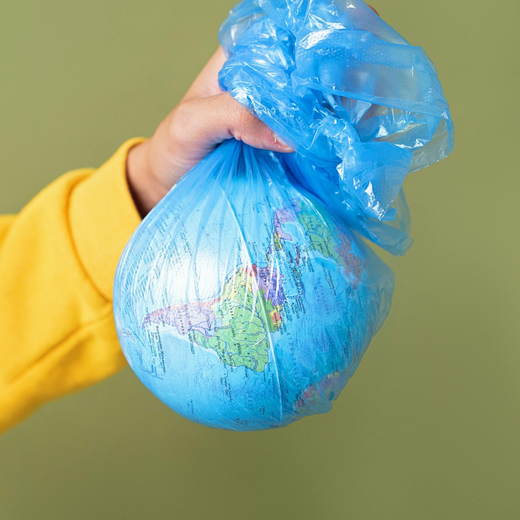 Conceptual image of Earth wrapped in a plastic bag, symbolizing environmental concerns.