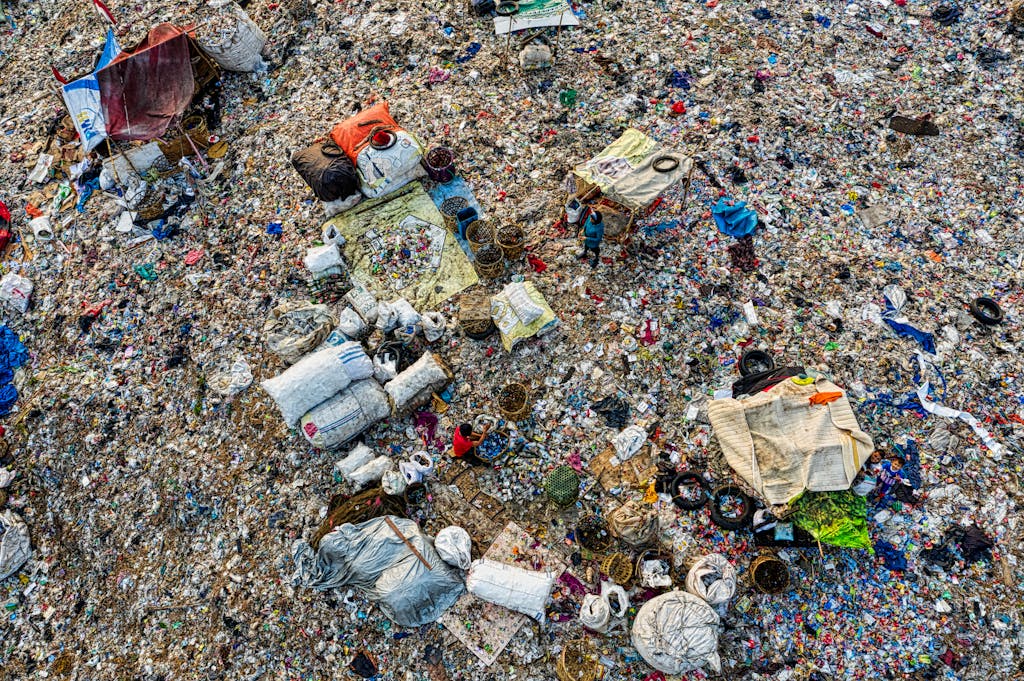An aerial shot capturing the cluttered expanse of a landfill, showcasing pollution and waste management.